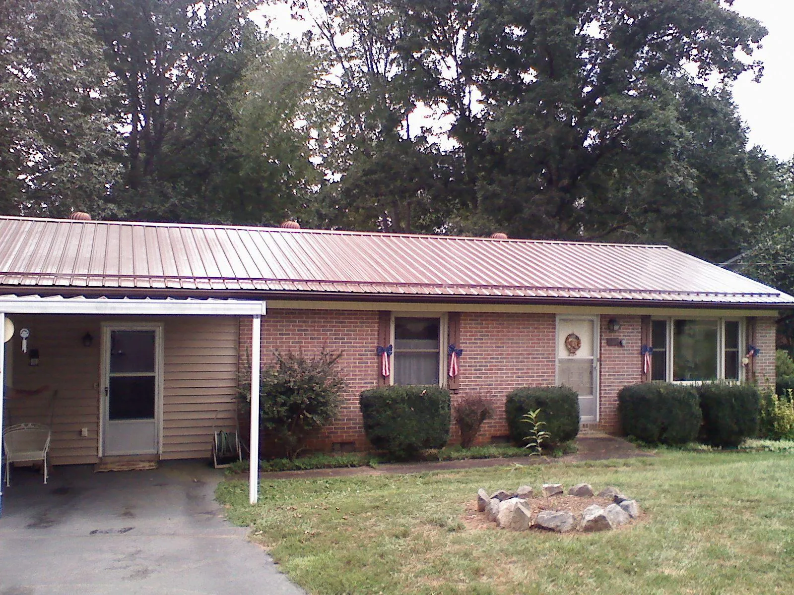 Bronze metal roof and carport on a brick ranch home — Roof Repair work by our crew in Nachusa